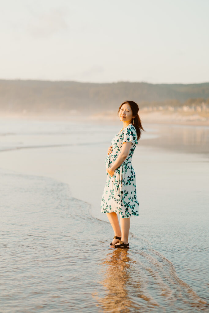 Cannon beach oregon maternity session featuring couple on the beach and in front of haystack rock. 